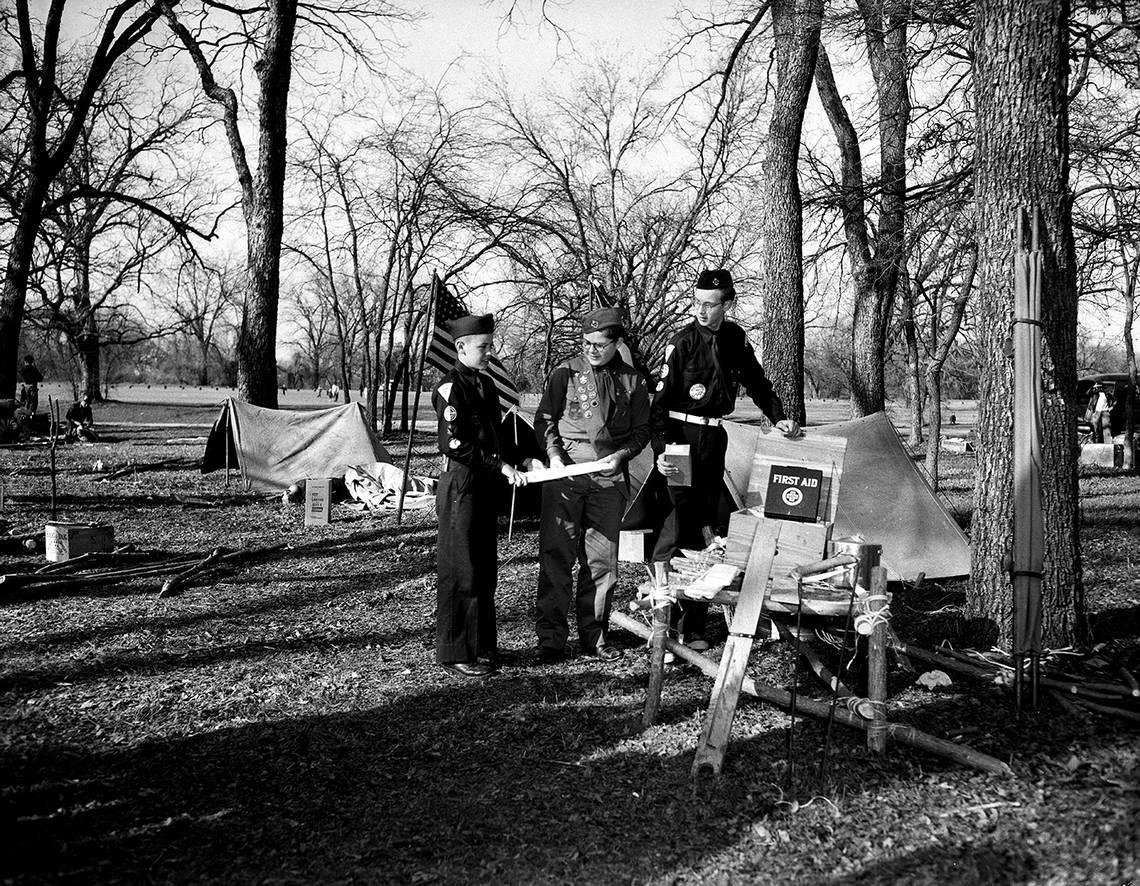 Feb. 13, 1954: Three members of Boy Scout Troop and Explorer Post 49 and the outdoor first aid display that helped them win first place in a scouting demonstration put on by the Horned Frog District of Longhorn Council. They are, left to right, Johnnie Grimmett, 2230 Mistletoe Dr.; Raymond Kinnear, 1651 Westmoreland, and Bill Miles, 2400 Park Pl. Fort Worth Star-Telegram archive/UT Arlington Special Collections