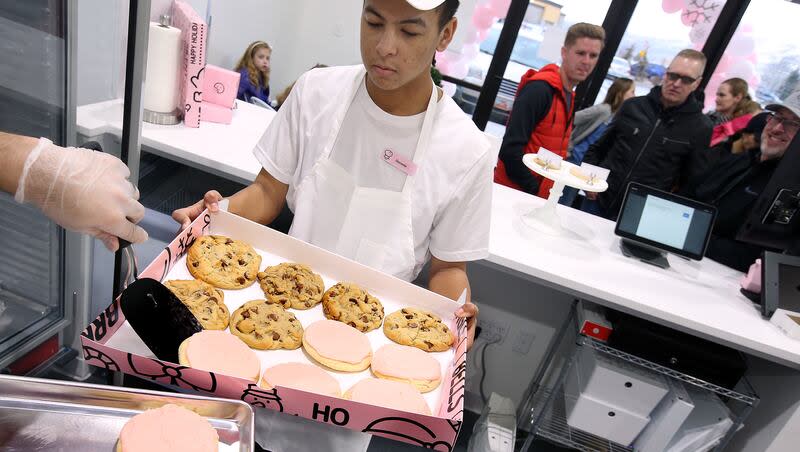 Deyonte Dennis prepares a party box of cookies for a customer at Crumbl in Lehi on Friday, Dec. 21, 2018. Crumbl has launched a Mini Monday promotion, which will allow customers to buy mini versions of its cookies once a week.