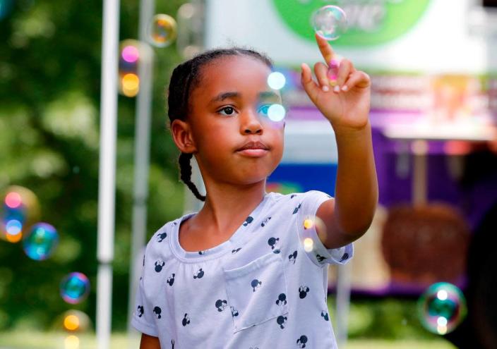 Maliah Bazzell, 6, of Knightdale plays with bubbles during the 2021 Capital City Juneteenth Celebration at Dorothea Dix Park in Raleigh on June 19, 2021.