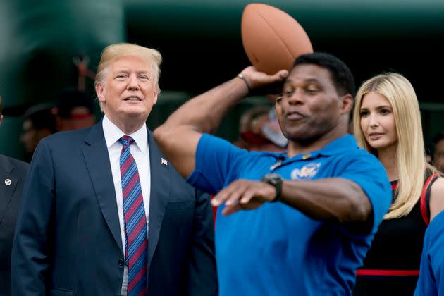 FILE - In this May 29, 2018 file photo, President Donald Trump, left, and his daughter Ivanka Trump, right, watch as former football player Herschel Walker, center, throws football's during White House Sports and Fitness Day on the South Lawn of the White House in Washington. The U.S. Senate nomination in a premier battleground like Georgia should be a plum political prize, but a year before Republican voters choose a nominee for the 2022 midterms, they have no clear options. The wildcard is whether football hero Herschel Walker runs and brings the endorsement of former President Donald Trump. (AP Photo/Andrew Harnik) (Photo: via Associated Press)