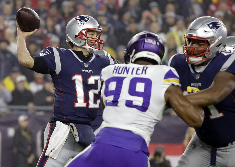 New England Patriots quarterback Tom Brady (12) passes under pressure from Minnesota Vikings defensive end Danielle Hunter (99) during the first half of an NFL football game, Sunday, Dec. 2, 2018, in Foxborough, Mass. (AP Photo/Steven Senne)