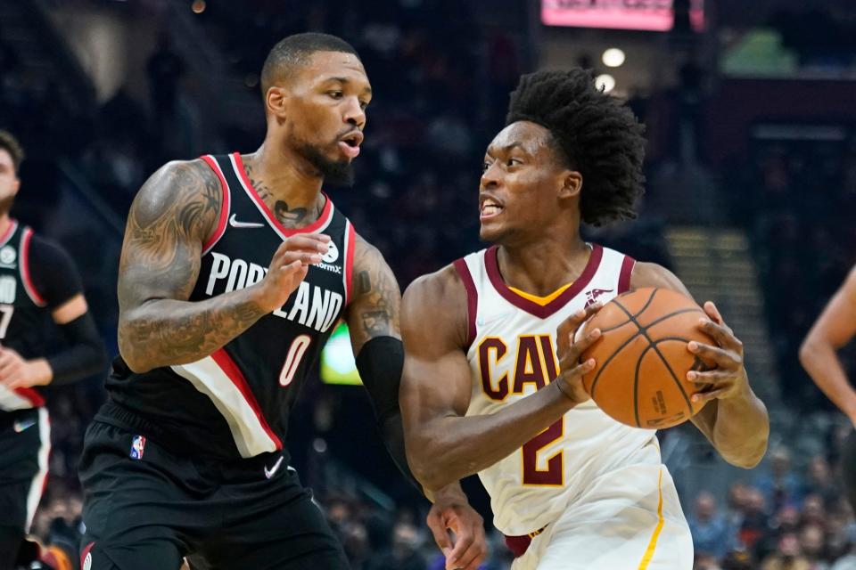 Cleveland Cavaliers' Collin Sexton (2) drives against Portland Trail Blazers' Damian Lillard (0) during the first half of an NBA basketball game Wednesday, Nov. 3, 2021, in Cleveland. (AP Photo/Tony Dejak)