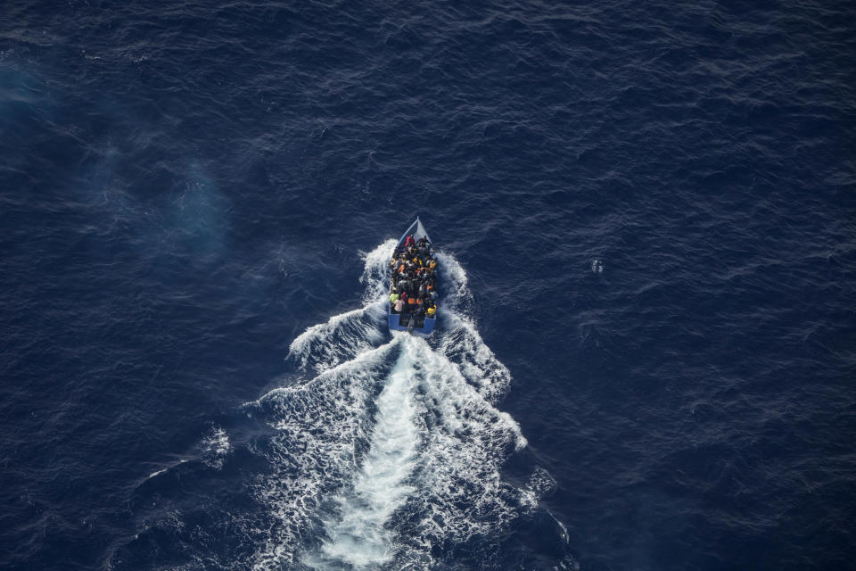 An overcrowded migrant boat tries to escape from the Libyan Coast Guard in the Mediterranean Sea, Wednesday, June 30, 2021. A non-profit sea rescue group is denouncing the Libyan Coast Guard and the European Union after it witnessed and filmed the Libyan maritime authorities chasing a crowded migrant boat and shooting in its direction as it tried to stop it from crossing the Mediterranean Sea to Europe. The video was filmed Wednesday by members of Sea-Watch as they flew over the Central Mediterranean during an observation mission and caught the incident on camera from their plane. (Sea-Watch.org via AP)