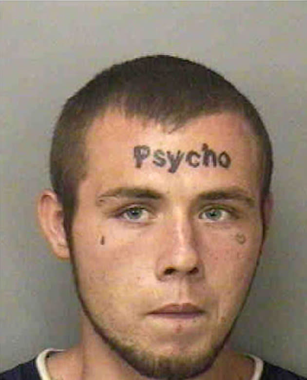 Justin Bebee, 21, from Florida has 'Psycho' in thick letters tattooed on his forehead (Rex Features)