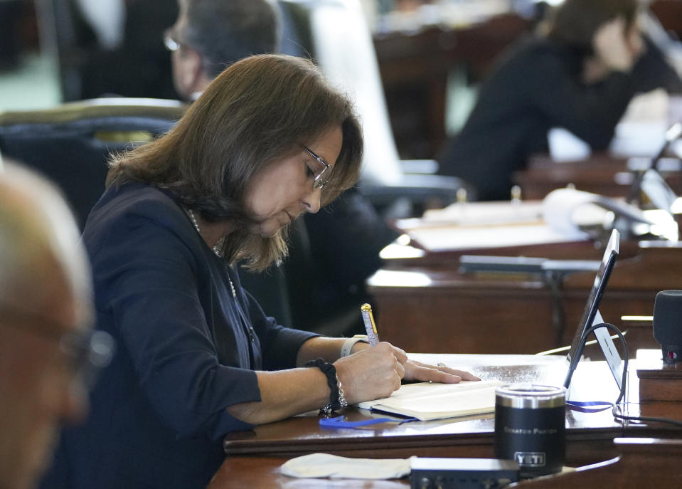 Texas state Sen. Angela Paxton, R - McKinney, takes notes at the impeachment trial of her husband Attorney General Ken Paxton at the Capitol, Thursday, Sept. 7, 2023, in Austin, Texas. (Jay Janner/Austin-American Statesman via AP, Pool)