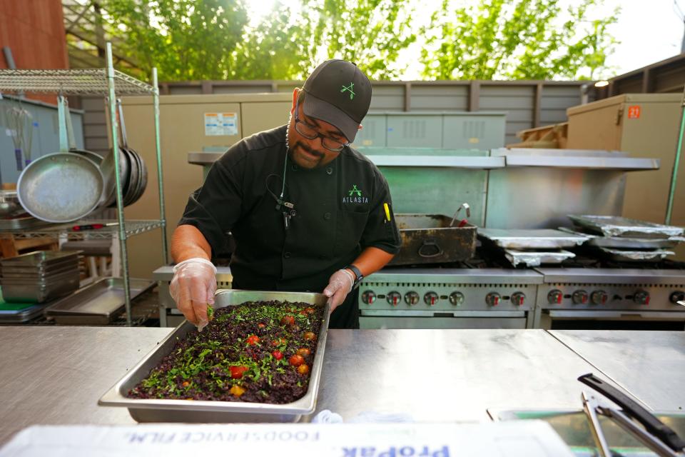 Catering chef Juan Gallardo preps the Forbidden Black Rice for guests during an ASU event catered by Atlasta Catering.