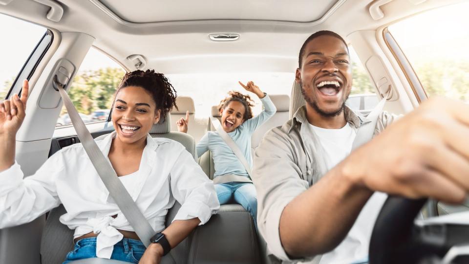 dad and daughter singing while riding in a car