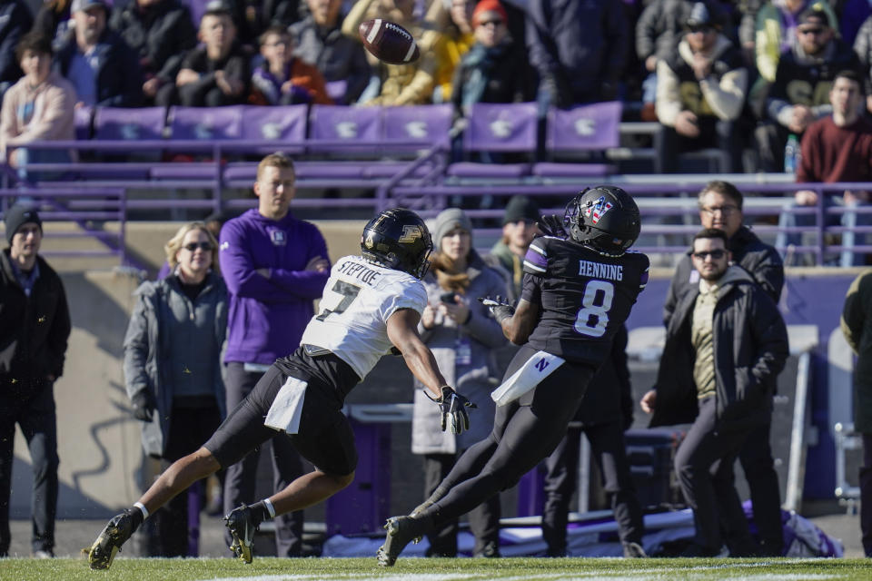 Northwestern wide receiver A.J. Henning, right, catches a pass from quarterback Ben Bryant during the first half of an NCAA college football game against Purdue, Saturday, Nov. 18, 2023, in Evanston, Ill. (AP Photo/Erin Hooley)