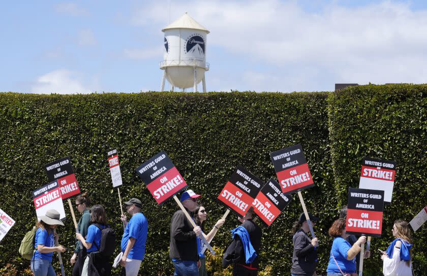 Striking writers take part in a rally in front of Paramount Pictures studio, Tuesday, May 2, 2023, in Los Angeles. Television and movie writers launched a strike for the first time in 15 years, as Hollywood girded for a walkout with potentially widespread ramifications in a fight over fair pay in the streaming era. (AP Photo/Chris Pizzello)