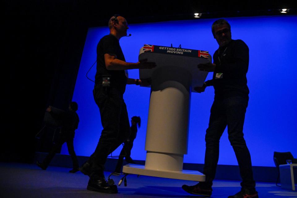 Workers prepare a speaker's podium during Britain's Conservative Party's annual conference (REUTERS)