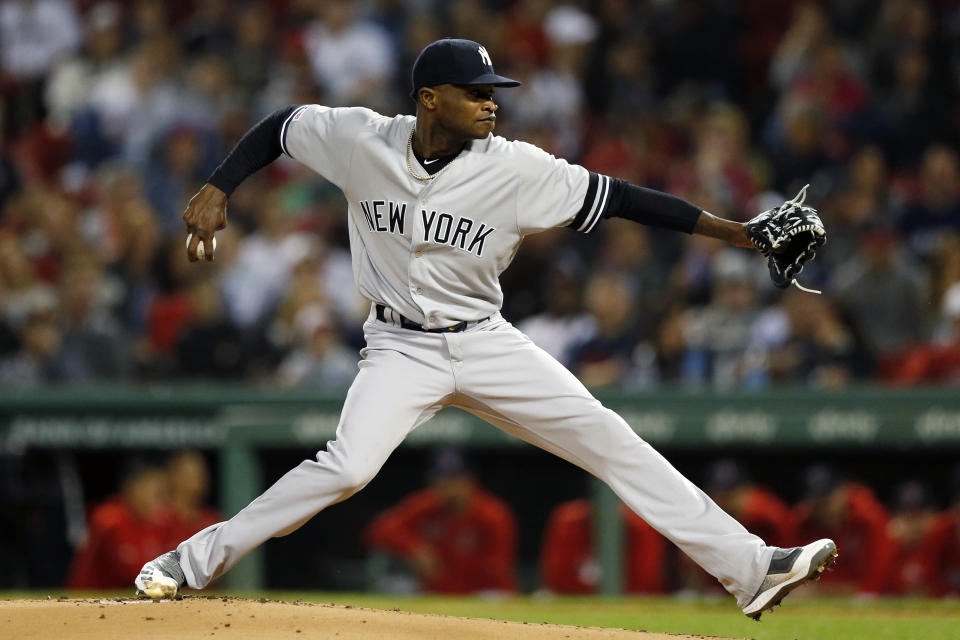 FILE - In this Sept. 6, 2019, file photo, New York Yankees' Domingo German pitches during the first inning of the team's baseball game against the Boston Red Sox, in Boston. Yankees pitcher Domingo German will miss the first 63 games of the 2020 season as part of an 81-game ban for violating Major League Baseball’s domestic violence policy. The league announced the suspension Thursday, Jan. 2, 2020. German has agreed not to appeal. (AP Photo/Michael Dwyer, File)
