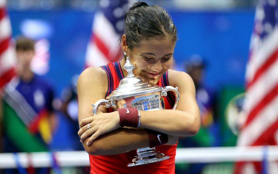 Emma Raducanu of Great Britain celebrates with the championship trophy - Elsa/Getty Images