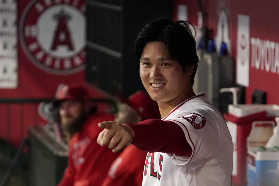 Los Angeles Angels designated hitter Shohei Ohtani gestures to other players in the dugout during the first inning of a baseball game against the Houston Astros Thursday, Sept. 23, 2021, in Anaheim, Calif. (AP Photo/Mark J. Terrill)