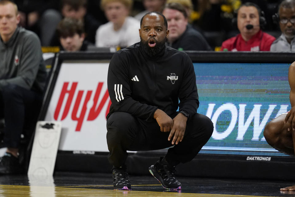 Northern Illinois head coach Rashon Burno watches from the bench during the first half of an NCAA college basketball game against Iowa, Friday, Dec. 29, 2023, in Iowa City, Iowa. (AP Photo/Charlie Neibergall)