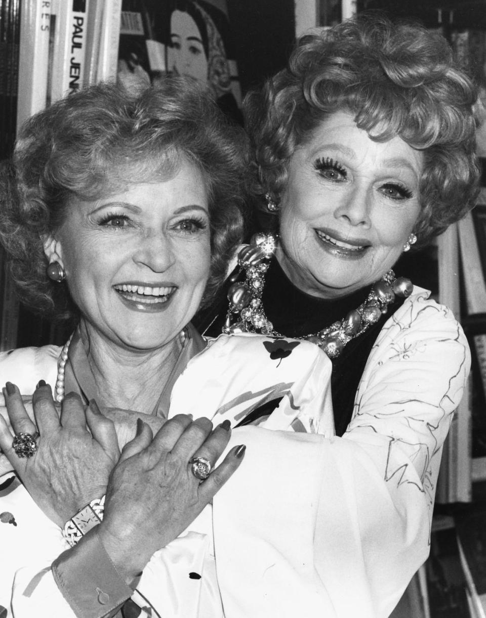 <p>Betty shares a hug with her friend, comedian Lucille Ball, at a book signing in Los Angeles. </p>