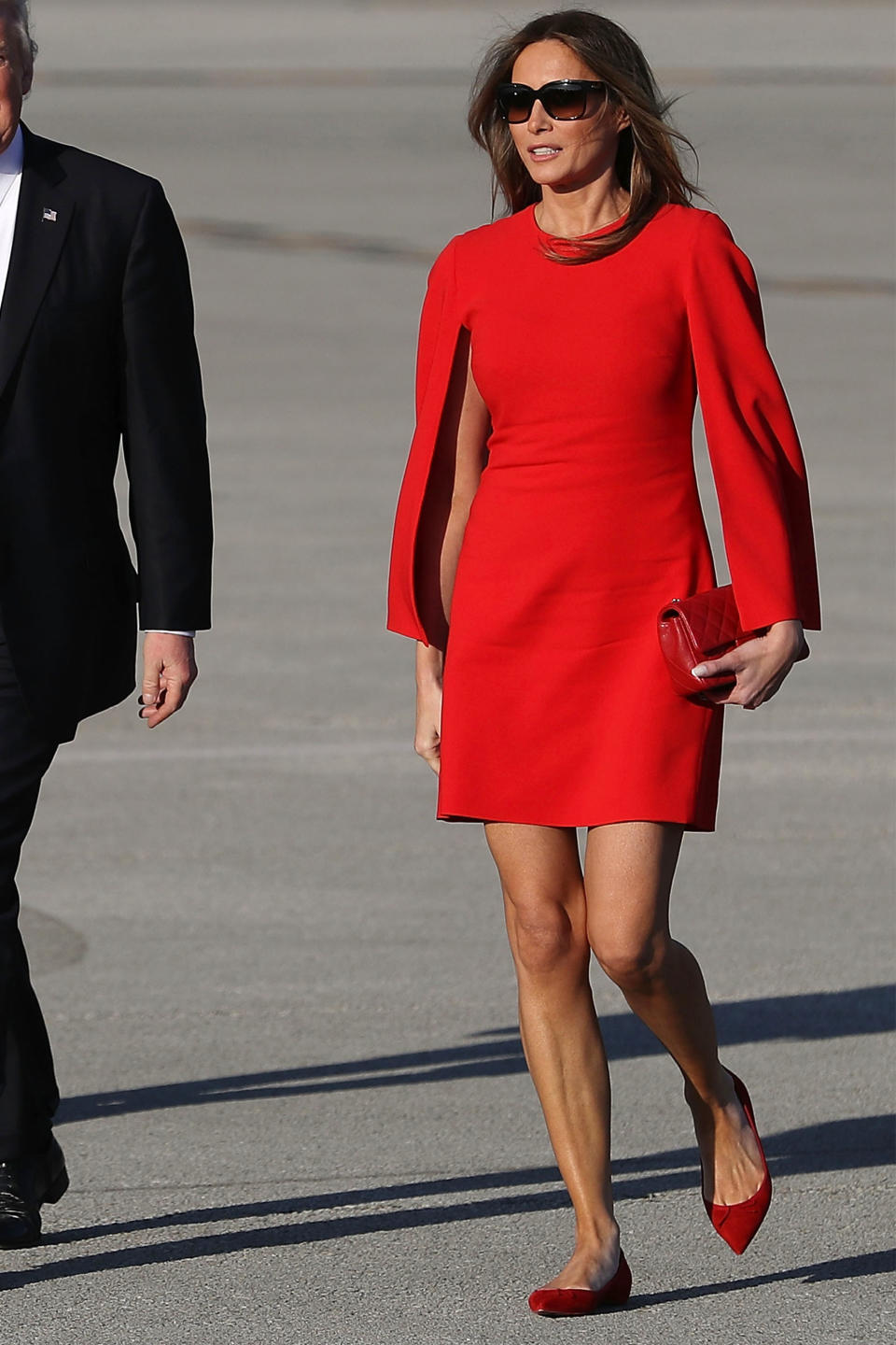 In a red Givenchy dress and flats while landing at the Palm Beach Airport to meet President Trump at Mar-a-Lago. (Photo: Getty Images)