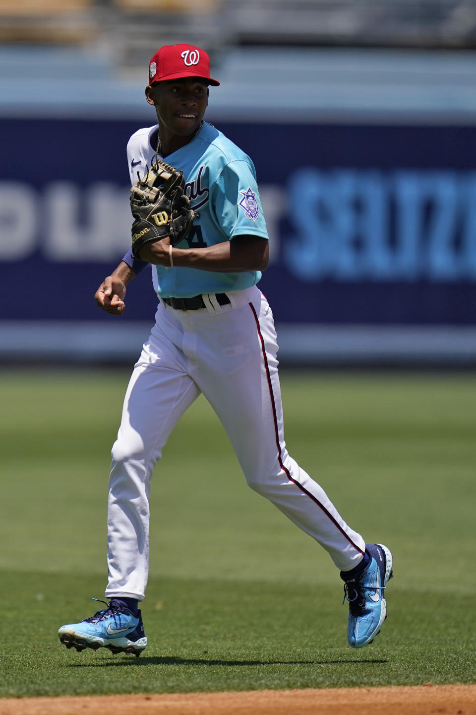 Darren Baker, of the Washington Nationals, warms up before the MLB All-Star Futures baseball game, Saturday, July 16, 2022, in Los Angeles. (AP Photo/Jae C. Hong)