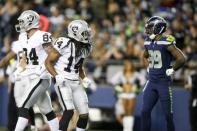 Aug 30, 2018; Seattle, WA, USA; Oakland Raiders wide receiver Keon Hatcher (14) celebrates after catching a touchdown pass against the Seattle Seahawks during the second quarter at CenturyLink Field. Seattle Seahawks defensive back Dontae Johnson (39) is at right. Mandatory Credit: Joe Nicholson-USA TODAY Sports