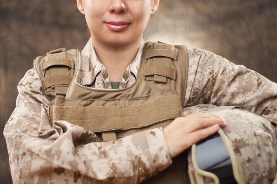 <p>Getty</p> A stock image of a female U.S. Marine soldier in combat gear.