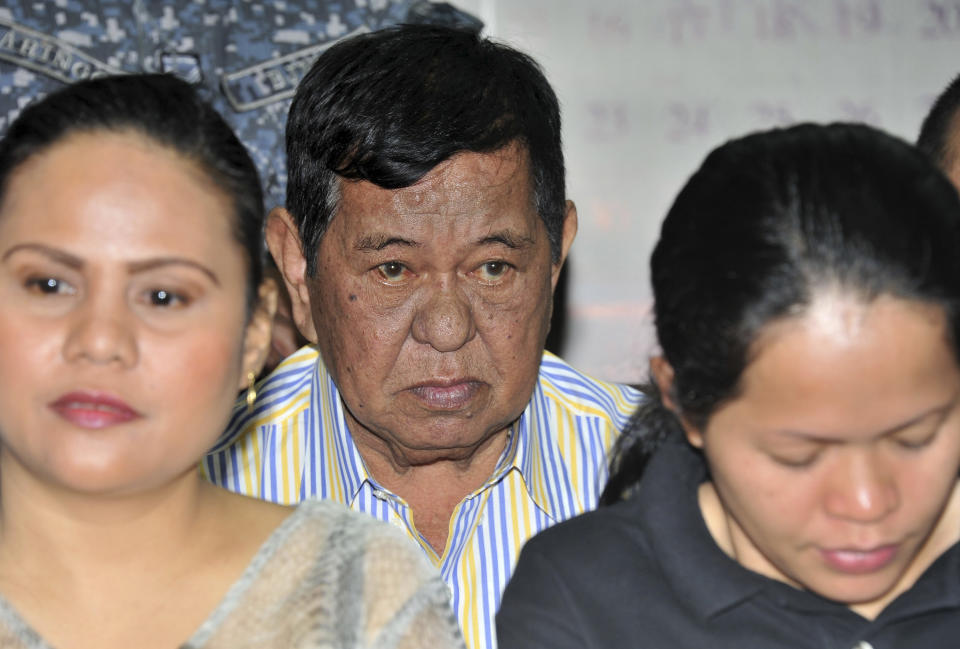 Andal Ampatuan Sr. , center, a powerful Filipino clan leader who is a suspect in the 2009 massacre of 57 people, listens during his arraignment on electoral sabotage at the Pasay city regional trial court, south of Manila, Philippines on Monday March 26, 2012. Andal Sr. has been on trial for murder and on Monday pleaded not guilty to charges of rigging elections to favor former President Gloria Macapagal Arroyo's allies. (AP Photo/Noel Celis, Pool)