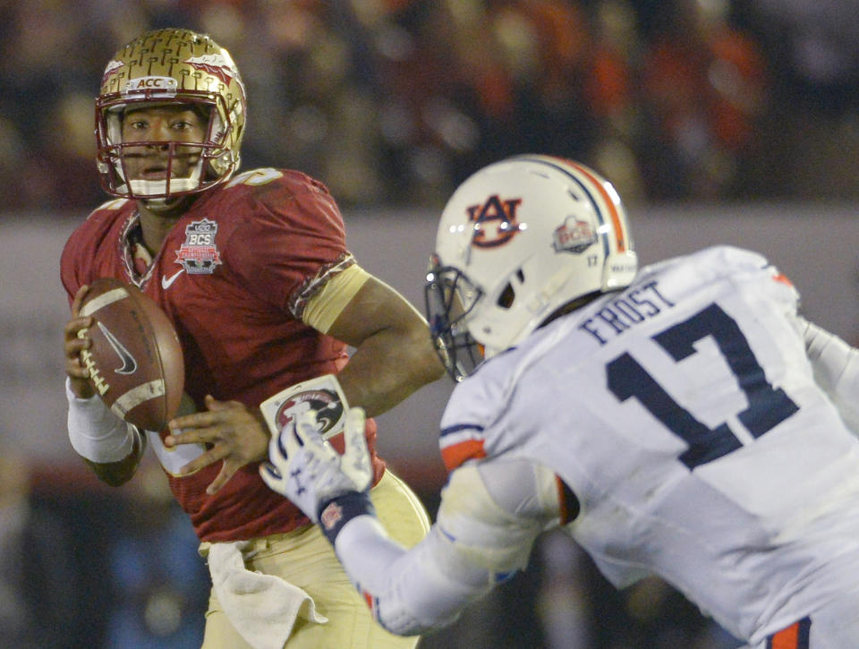 Florida State's Jameis Winston looks to pass with Auburn's Kris Frost defending during the second half of the NCAA BCS National Championship college football game Monday, Jan. 6, 2014, in Pasadena, Calif. (AP Photo/Mark J. Terrill)