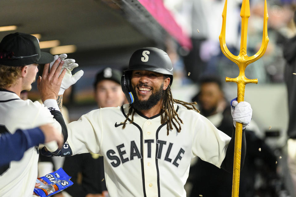 Seattle Mariners' J.P. Crawford celebrates after his solo home-run against the Chicago White Sox in the dugout during the first inning of a baseball game, Saturday, June 17, 2023, in Seattle. (AP Photo/Caean Couto)