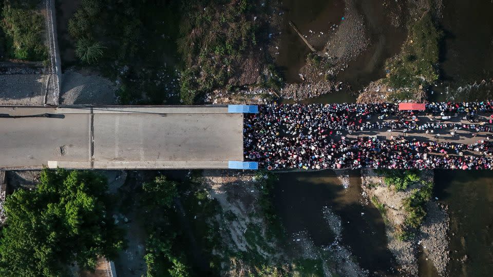 People wait in Ouanaminthe, Haiti to cross into Dajabon, Dominican Republic, Friday, May 17, 2024. The Dominican Republic’s election on May 19 has been marked by calls for more migratory crackdowns and finishing a border wall dividing the countries. - Matias Delacroix/AP