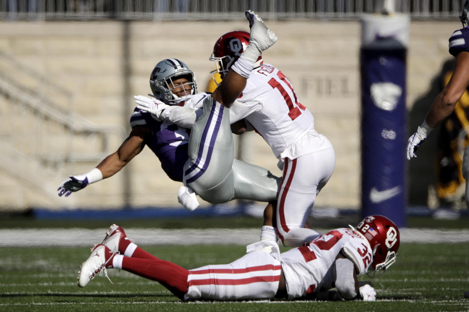 Kansas State running back James Gilbert is tackled by Oklahoma safety Pat Fields (10) during the first half of an NCAA college football game Saturday, Oct. 26, 2019, in Manhattan, Kan. (AP Photo/Charlie Riedel)