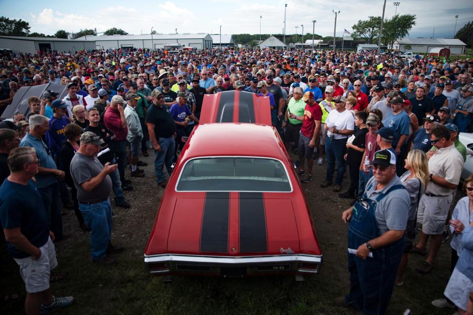 Onlookers attend the Coyote Johnson Vanderbrink Car Auction on Sept. 14, 2019 in Red Oak, Ia. Coyote Johnson of Red Oak has collected over 90 muscle cars since age 16, and kept a select few models following the auction. 

