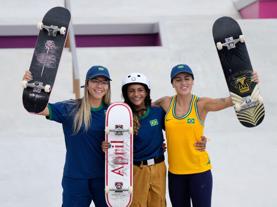 Brazilian skateboarders Pamela Rosa, left, Rayssa Leal, center, and Leticia Bufoni pose before competition starts at Tokyo 2020.