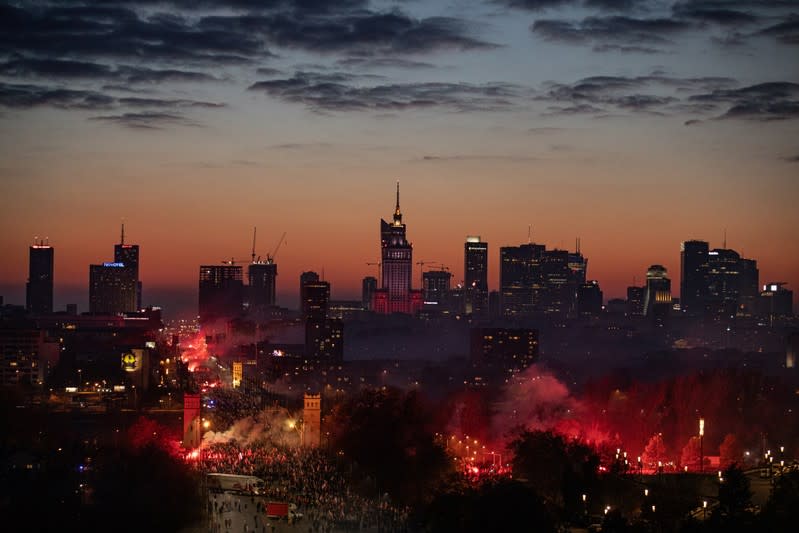 People burn flares during a march marking the National Independence Day in Warsaw