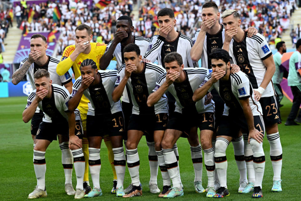 (Top, L-R) Germany's defender #03 David Raum, goalkeeper #01 Manuel Neuer, defender #02 Antonio Ruediger, midfielder #07 Kai Havertz, defender #15 Niklas Suele and defender #23 Nico Schlotterbeck and (Bottom, L-R) midfielder #06 Joshua Kimmich, forward #10 Serge Gnabry, midfielder #14 Jamal Musiala, forward #13 Thomas Mueller and midfielder #21 Ilkay Gundogan cover their mouths as they pose for the team picture ahead of the Qatar 2022 World Cup Group E football match between Germany and Japan at the Khalifa International Stadium in Doha on November 23, 2022. (Photo by Ina Fassbender / AFP)