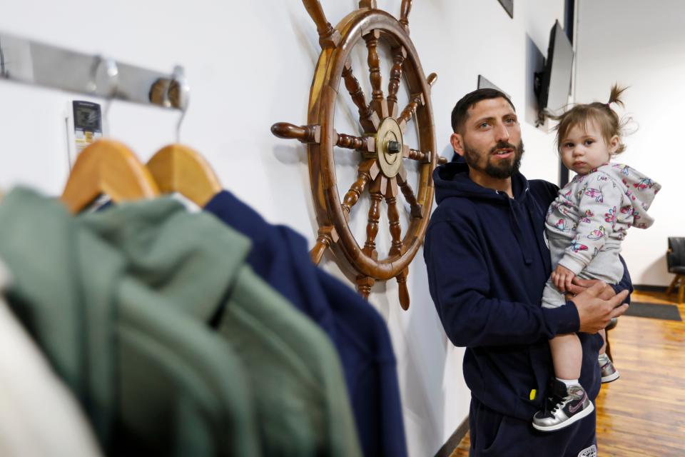 Peter Farland and his daughter Ahriel Farland, 1, at the newly opened Gear to Go Fishing Supply at the Killburn Mill in New Bedford.