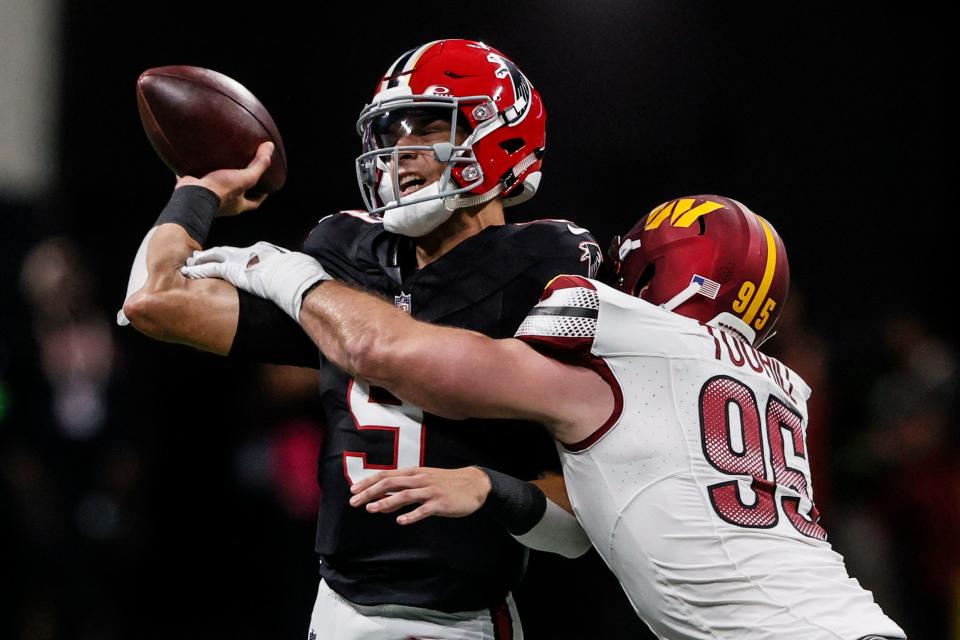 Atlanta Falcons quarterback Desmond Ridder (9) passes the ball under pressure by Washington Commanders defensive end Casey Toohill (95) during the first half of an NFL football game, Sunday, Oct. 15, 2023, in Atlanta.