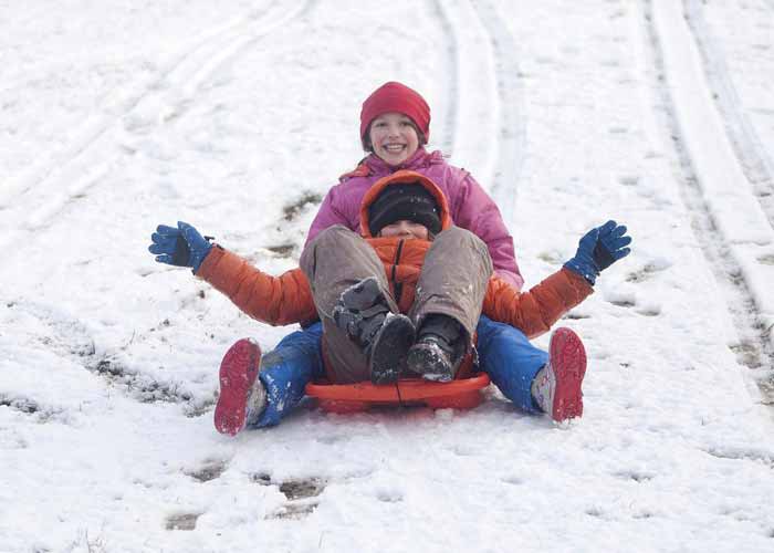 Max and Ursula Lantvia from Glasgow play in the snow in Kelvingrove Park on a sledge. The first significant snow this winter has hit Scotland with many parts of the west, the central belt, Dumfries and Galloway and the Highlands affected.