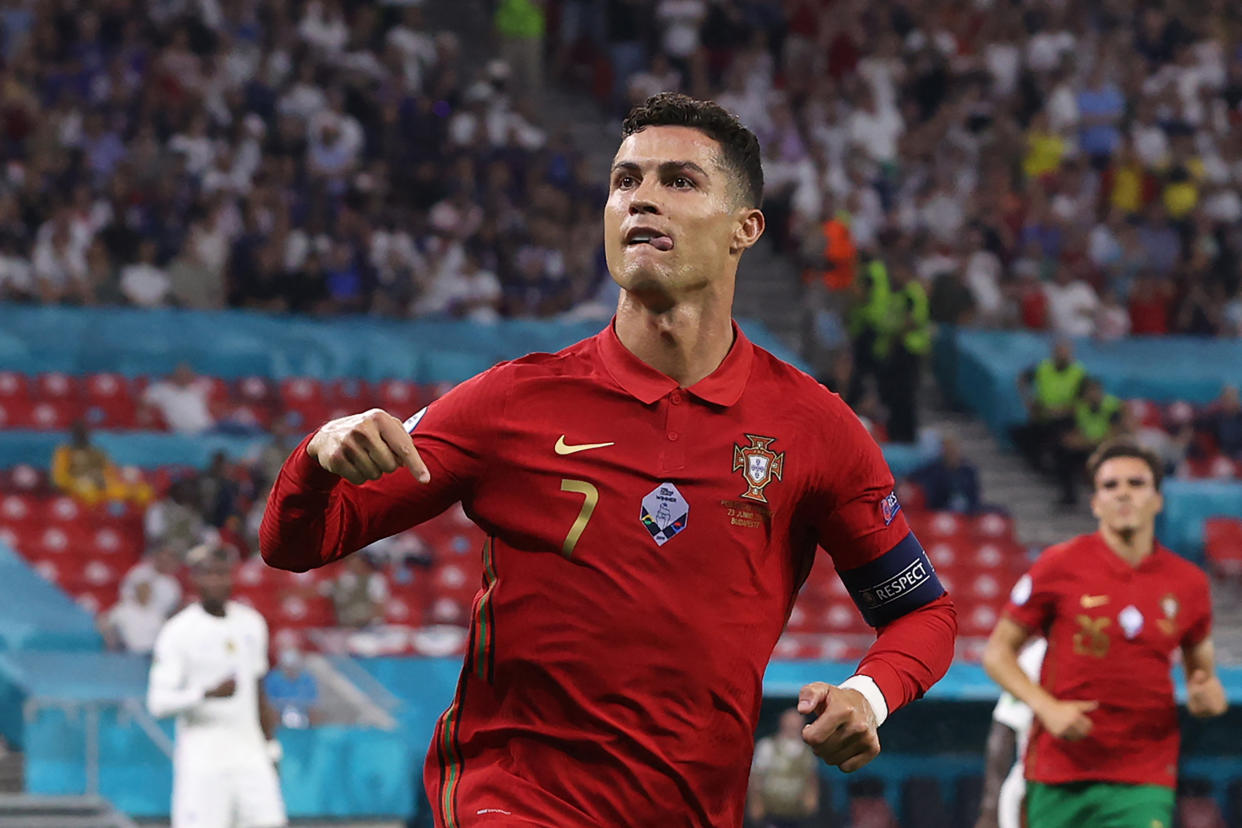 Cristiano Ronaldo celebrates after tying the international men's scoring record with his 109th goal for Portugal. (Photo by BERNADETT SZABO/POOL/AFP via Getty Images)