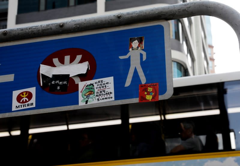 A sticker bearing an image of Hong Kong's Chief Executive Carrie Lam is attached on a road sign in Hong Kong