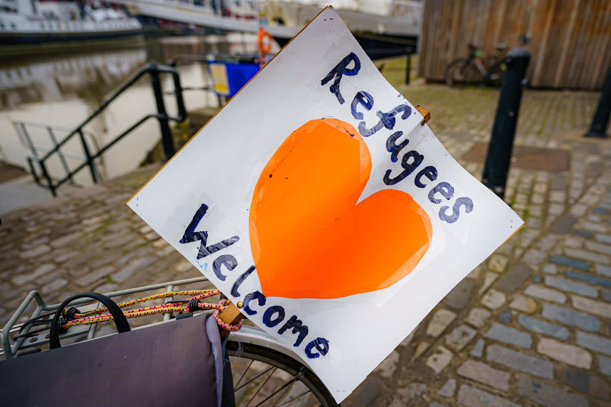 A ‘refugees welcome’ banner attached to a bicycle (Ben Birchall/PA) (PA Wire)