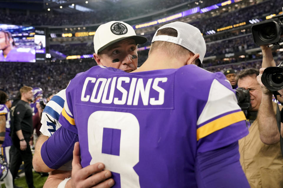 Indianapolis Colts quarterback Matt Ryan talks with Minnesota Vikings quarterback Kirk Cousins (8) after an NFL football game, Saturday, Dec. 17, 2022, in Minneapolis. The Vikings won 39-36 in overtime. (AP Photo/Abbie Parr)