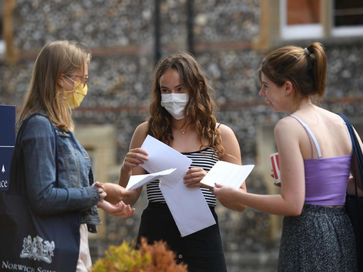 Benita Stipp (centre) and Mimi Ferguson (left) react as students at Norwich School, Norwich, receive their A-Level results: PA