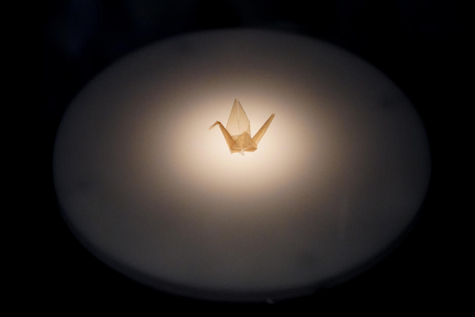 A small paper crane folded by Sadako Sasaki, a Japanese girl who died from radiation poisoning after the atomic bomb was dropped on Hiroshima, is on display at the Harry S. Truman Presidential Library and Museum Wednesday, June 9, 2021, in Independence, Mo. The facility will reopen July 2 after a nearly $30 million renovation project. (AP Photo/Charlie Riedel)