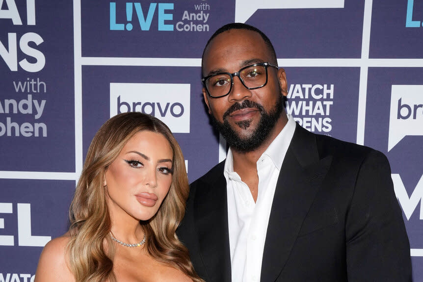 Larsa Pippen and Marcus Jordan posing together in front of a step and repeat at the Watch What Happens Live clubhouse in New York City.