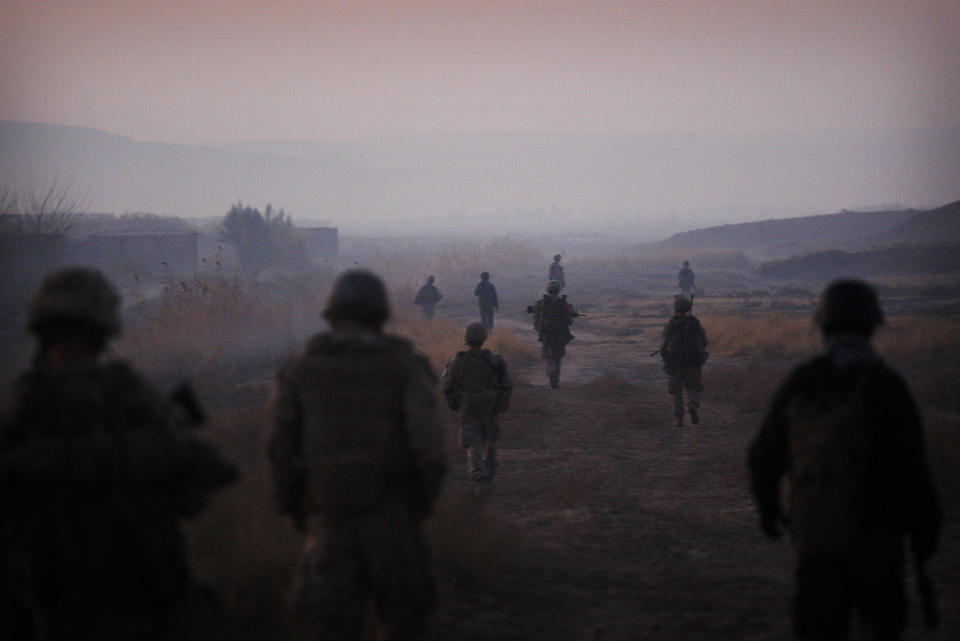 FILE - In this Dec. 23, 2009, file photo United States Marines from the 2nd Battalion 2nd Marines "Warlords" and Afghan National Army soldiers walk in formation during an operation in the Garmsir district of the volatile Helmand province, southern Afghanistan. (AP Photo/Kevin Frayer, File)