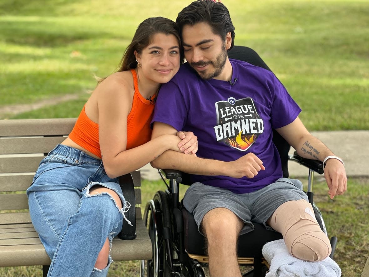 Emilia Ballester (left) pictured with her husband Carlos Bastarrachea (right) outside Providence Healthcare in Scarborough where he is undergoing care for his amputated left leg. (Farrah Merali/CBC News - image credit)