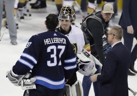 May 20, 2018; Winnipeg, Manitoba, CAN; Winnipeg Jets goaltender Connor Hellebuyck (37) shakes hands with Vegas Golden Knights goaltender Marc-Andre Fleury (29) after game five of the Western Conference Final of the 2018 Stanley Cup Playoffs at Bell MTS Place. Mandatory Credit: James Carey Lauder-USA TODAY Sports