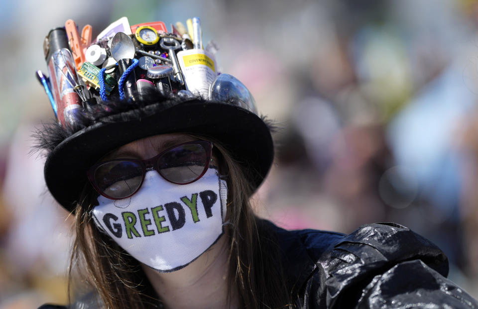 A protestor wears a protective facemask with message during a demonstration around the meeting of the G7 in Falmouth, Cornwall, England, Saturday, June 12, 2021. Leaders of the G7 gather for a second day of meetings on Saturday, in which they will discuss COVID-19, climate, foreign policy and the economy. (AP Photo/Alastair Grant)