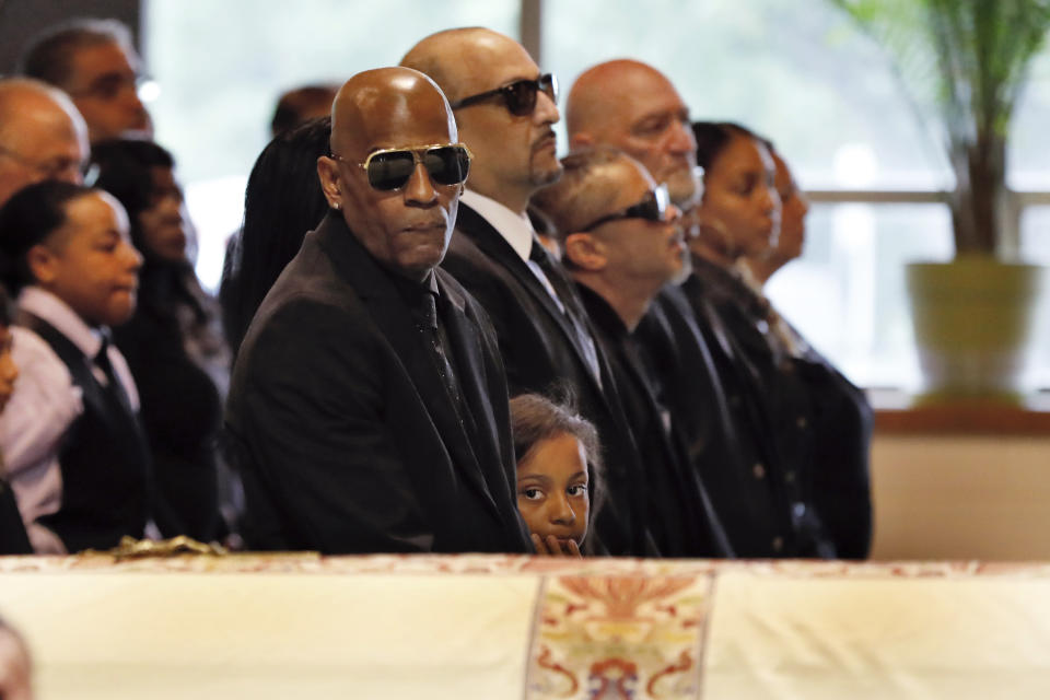 Freddy Cuevas, center, companion of Evelyn Rodriguez, looks at her casket during her funeral at Saint Anne's Roman Catholic Church, in Brentwood, N.Y., Friday, Sept. 21, 2018. Rodriguez, 50, is a mother recognized by President Donald Trump for turning grief over her daughter's suspected gang killing into a crusade against MS-13. She was struck and killed by an SUV on Sept. 14 after a heated confrontation with the driver over the placement of a memorial to her slain daughter, Kayla Cuevas. (AP Photo/Richard Drew)