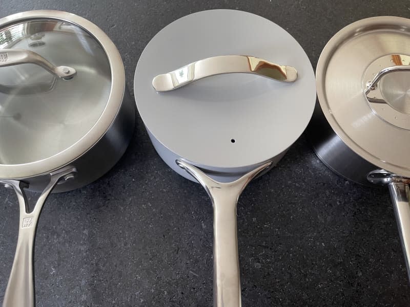 three saucepans on a countertop