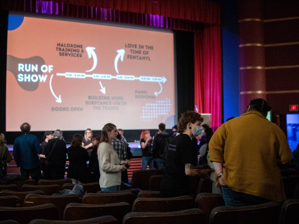 People gathered at the Metro Cinema in Edmonton on Thursday for a harm reduction event. Attendees received naloxone training and watched documentaries about the toxic drug supply. (Submitted by Reed Larsen - image credit)