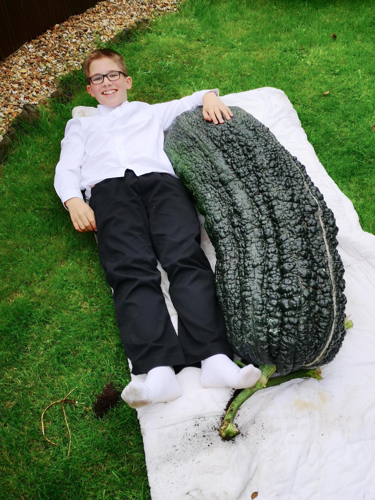 James Courtney-Fortey, aged 12, next to the gigantic marrow (Caters)